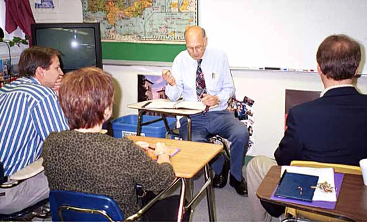 Faculty member Tollie Ross leads a “class” in German with parents sitting as students.