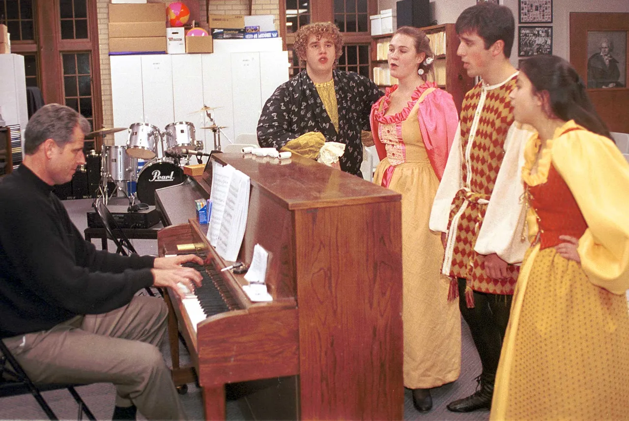 Students performing in the Feb. 2-4 performance of the musical <I>Kiss Me Kate</I> gather around the piano during a dress rehearsal.
