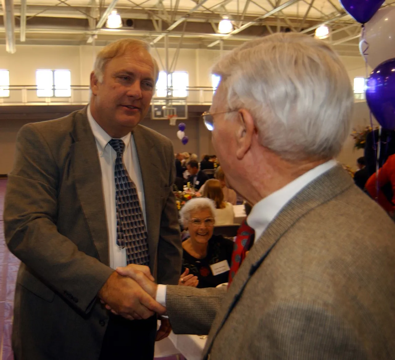 Van Es greets Charlie Davidson, former Darlington athletic director and head football coach)during the Athletic Center Dedication.