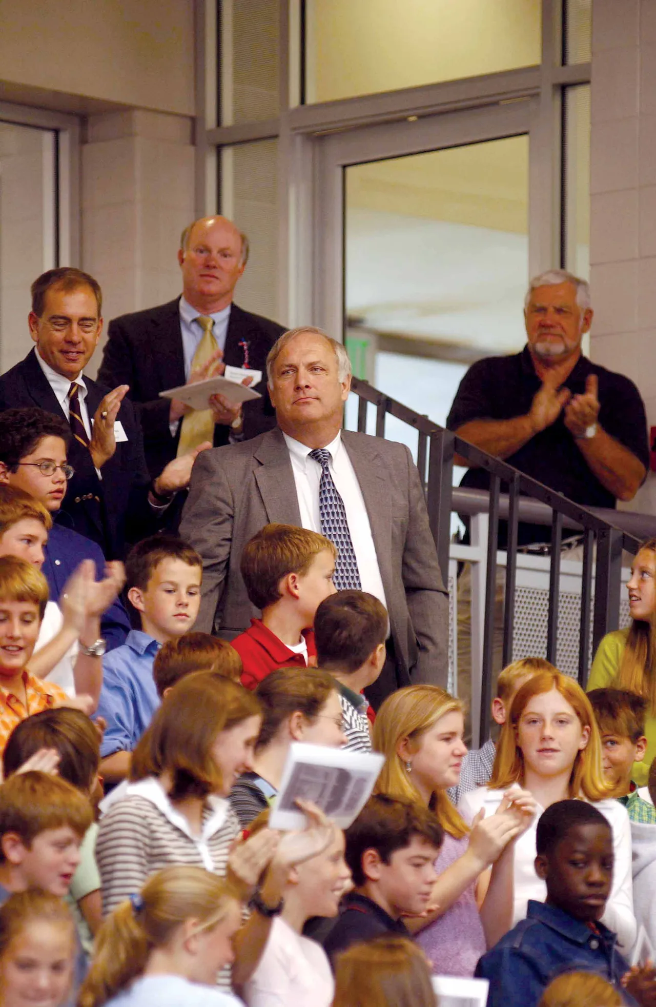 Slightly embarrassed, Jim Van Es stands as crowds applaud their approval that the arena bears his name.