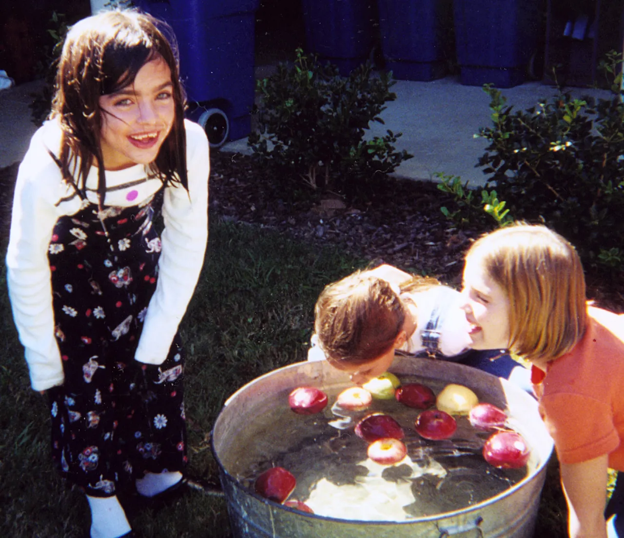 Katie Brewster, Allie MacKimm, and Sadie Brown bob for apples.
