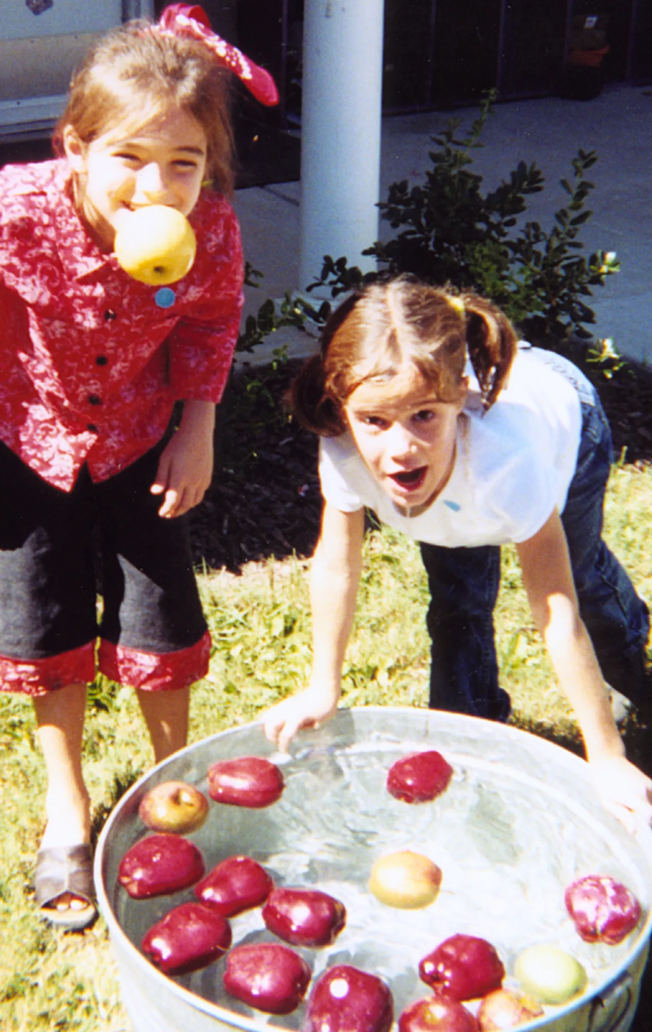 Kelsey Ann Williams and Lizzy Gilbert try for an apple a day.