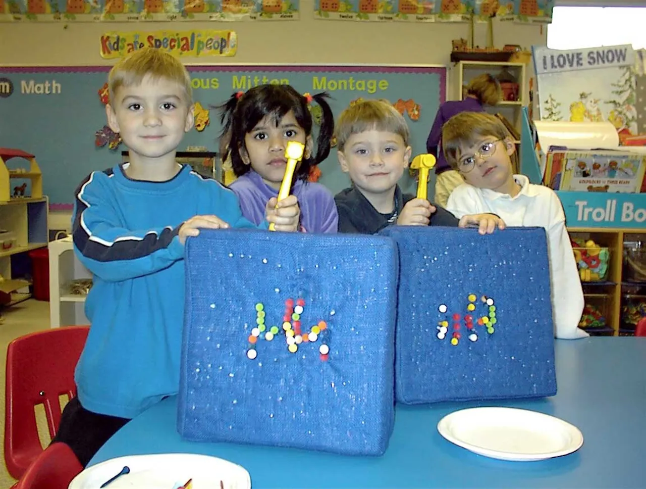 During “Hh” week, students hammer uppercase and lowercase Hh’s with golf tees. Will Mathis, Amita Reddy, Wil Taylor, and Nicolas Burgess show off their finished product.