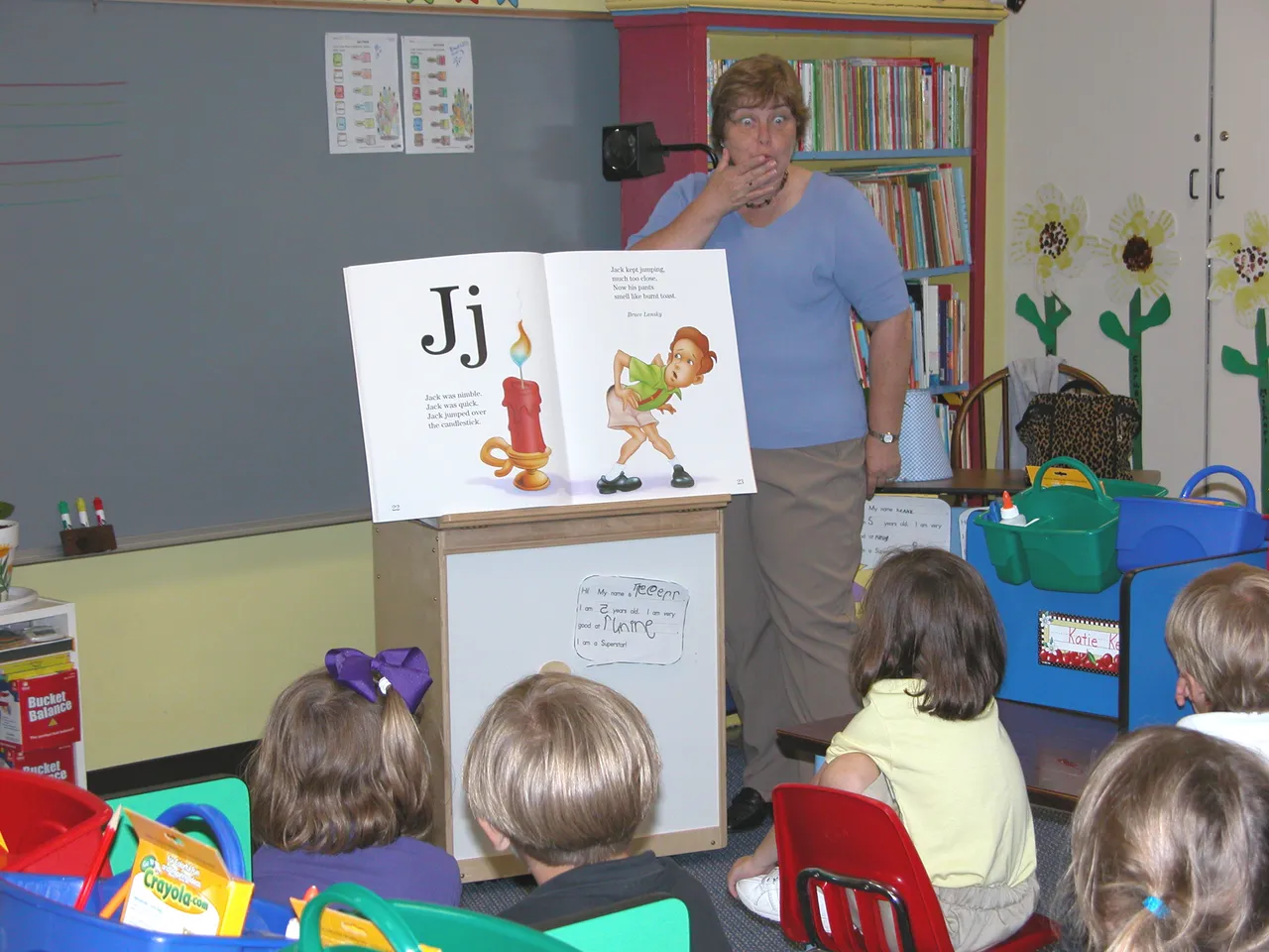 Kindergarten teacher Patricia Ayer is amazed at the success of her students as they make perfect "Js" in the air.