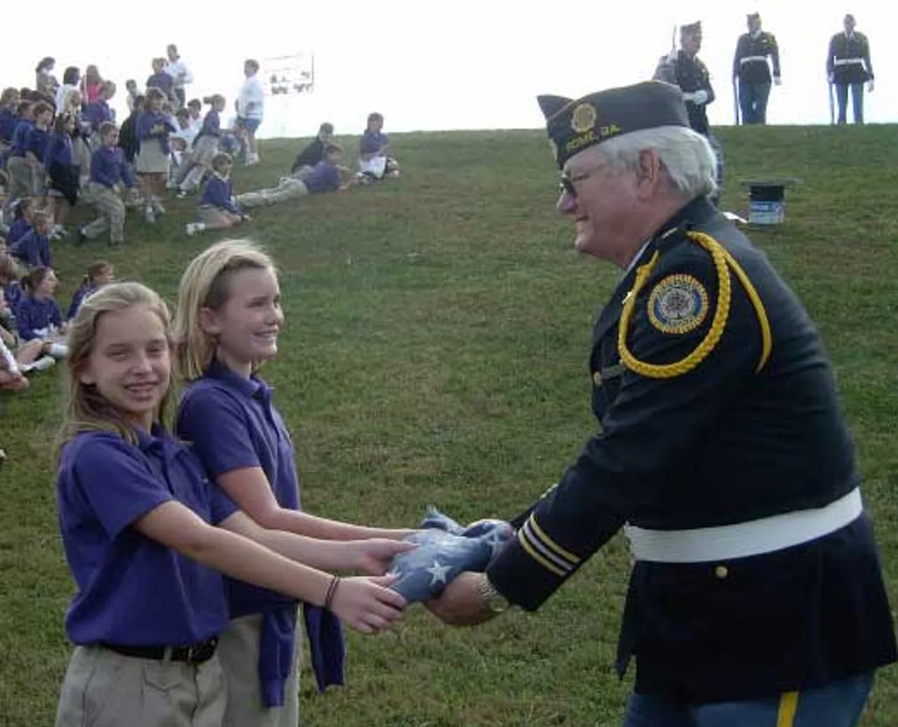 Darlington’s fourth graders turn their tattered flag over to be burned and accept a new flag from the Daughters of the American Revolution as part of the American Legion’s flag-disposal ceremony immediately following Rome’s Veterans Day observance. The fourth grade is responsible for raising and lowering the flag at Lower School each day.