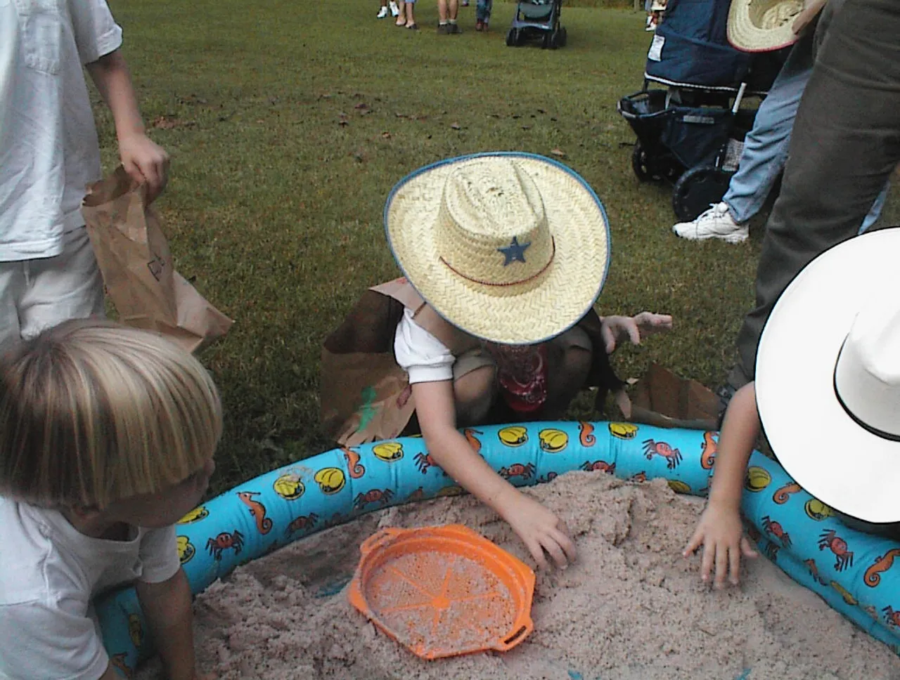 Pre-kindergarteners pan for a good time during Cowboy Day.