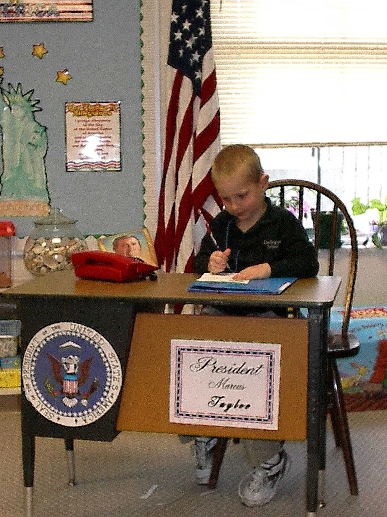 In the Oval Office of Darlington kindergarten sits President for a day, Marcus Tayloe.
