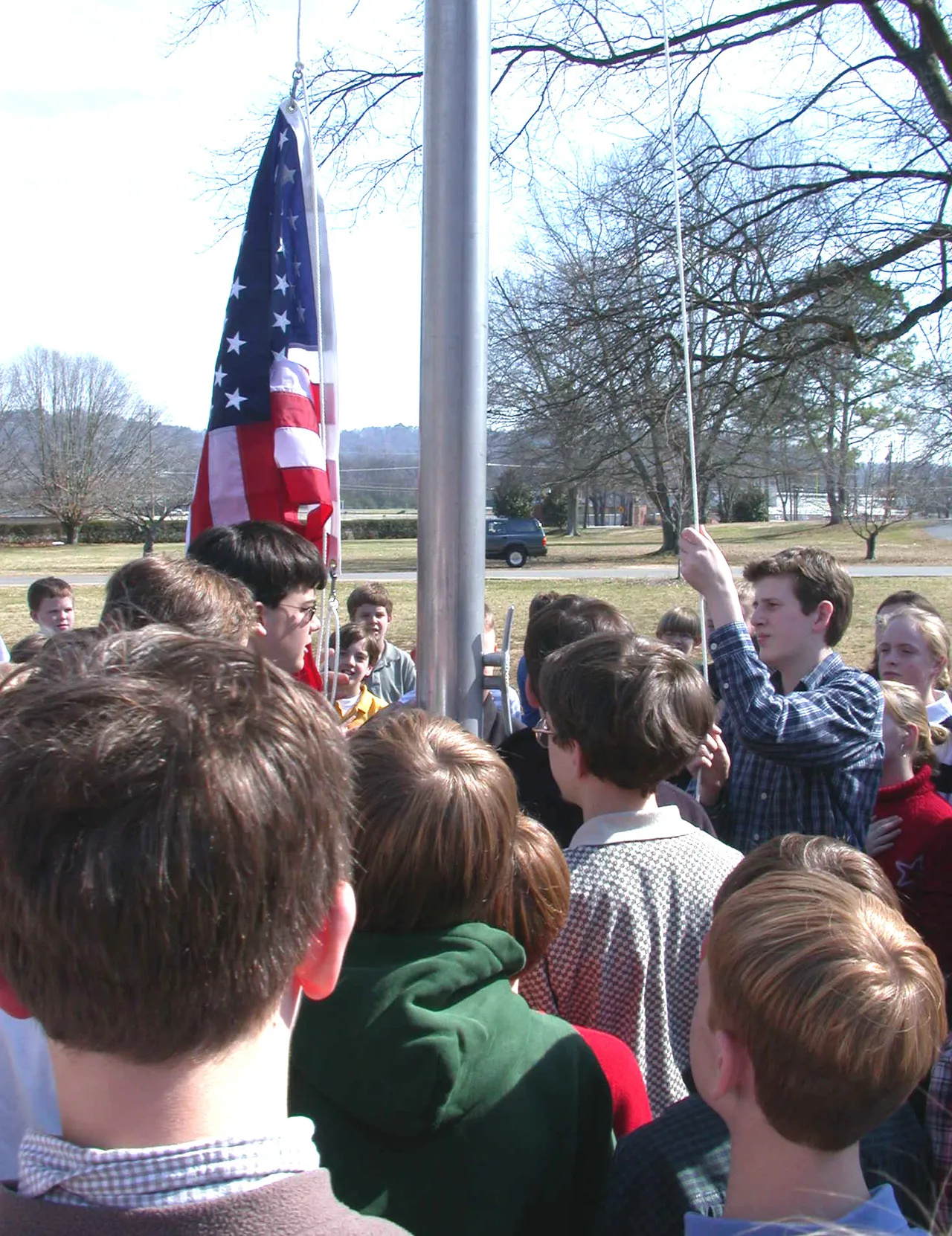 Eagle Scouts raise Middle School's new American flag.