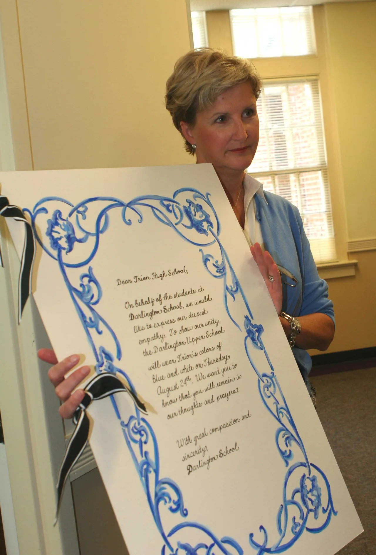 Director of Personal Counseling Jill Pate holds the card that was delivered to Trion High School Aug. 24.