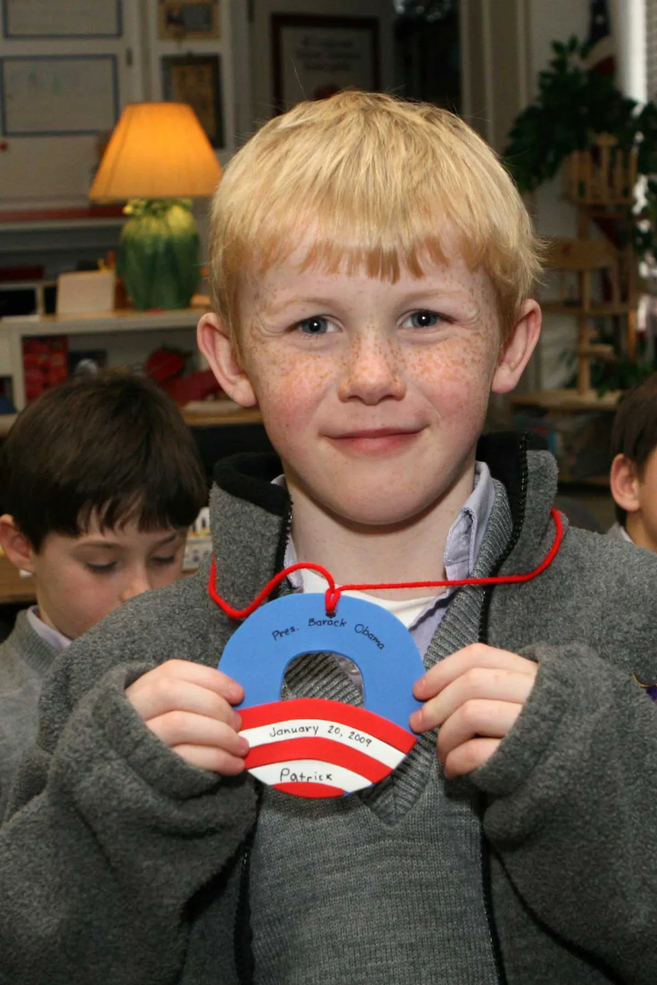 Pre-first grader Patrick Shealy shows off the inaugural medallion he made in class.
