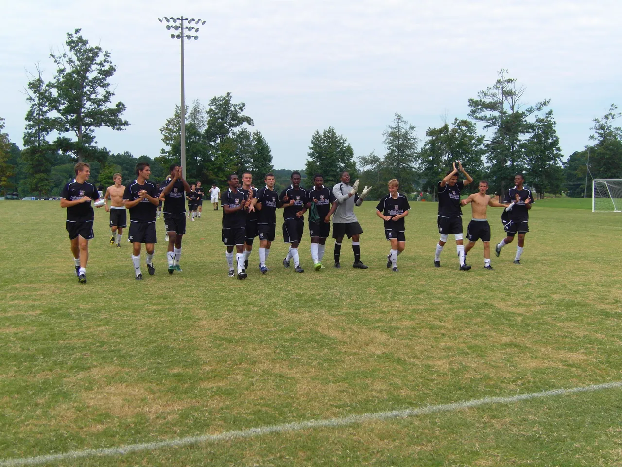 The U-19 boys celebrate their win as they come off the field.