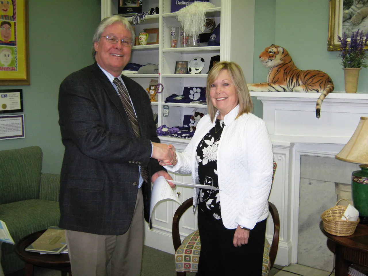 Steve Bartholomew, director of Lower School, presents a $100 check to Gretta Wilson of the Open Door Home.