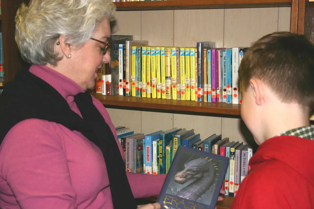 Mai Mai kelly, mother of sixth grader Jack, volunteers in the Book Nook.