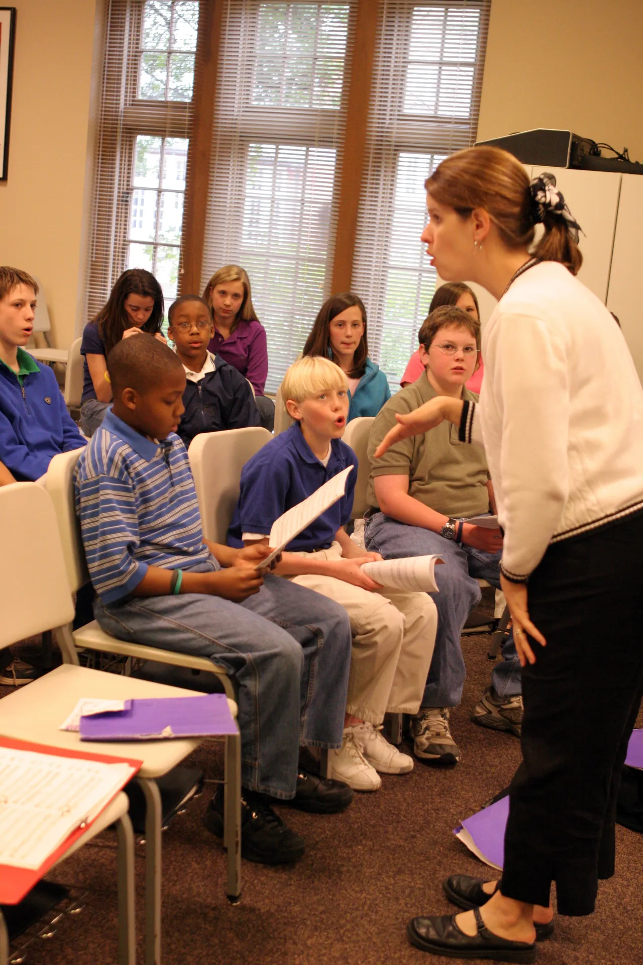 Kim Tunnell works with the Middle School Chorus.