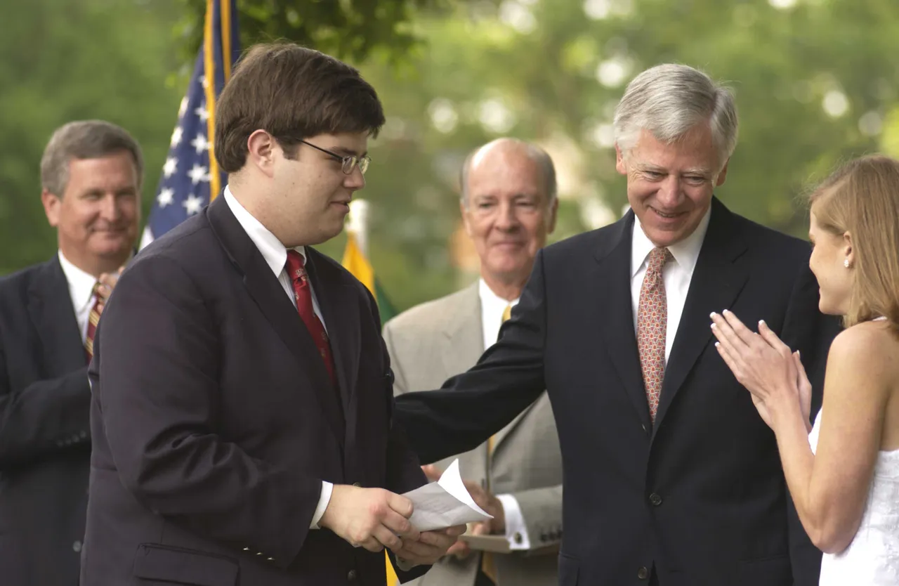 Payton Bradford and Anne Montgomery present President Jim Hendrix with an honorary diploma.