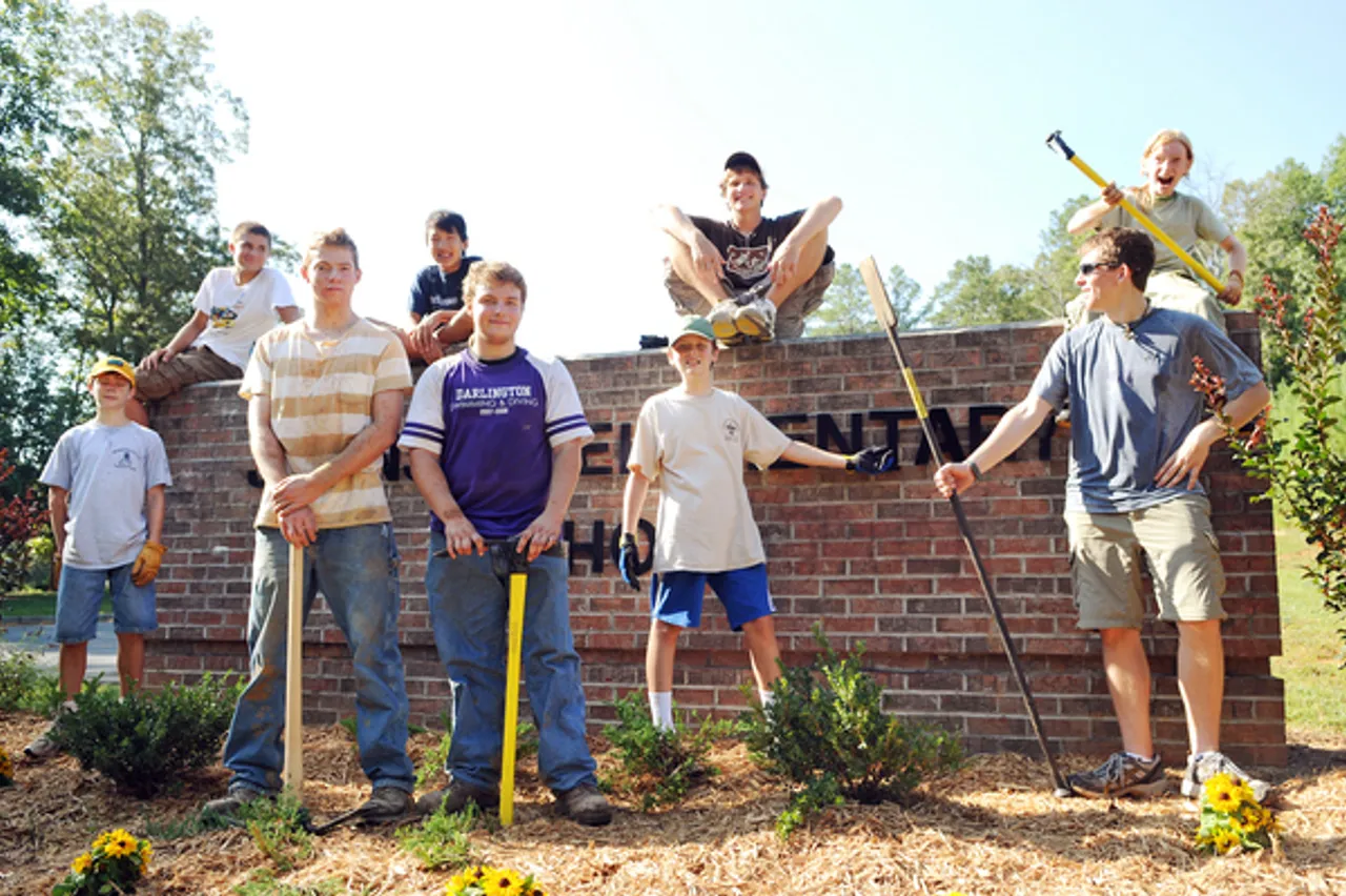 Jack Lynch (center) of Scout Troop 113 and friends worked on his Eagle Scout project, which consists of planting trees and refurbishing wooden picnic tables at Johnson Elementary School. Photo by Lindy Dugger Cordell, RN-T
