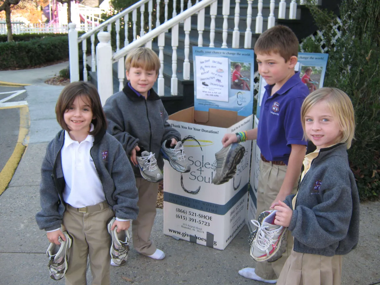 First-graders Katie Carlton, Cooper Cates, John Andrew Cash and Zoe Dillmon donate shoes to Soles4Souls.