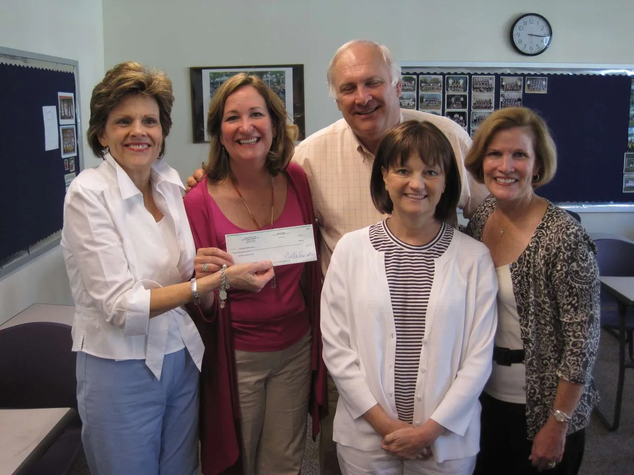 Angie Stegall and Laura Davis of the National Society of the Colonial Dames of America present a check to Eva Marie Burns, Kandi Riddle and Jim Van Es.