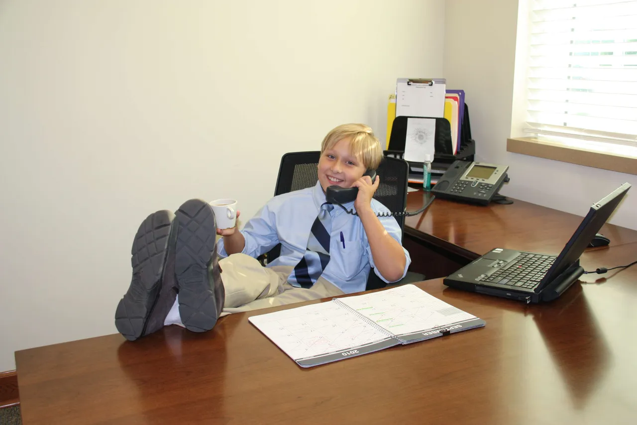 Jack McClain sits at Dr. Hutchins' desk during his day as division director.