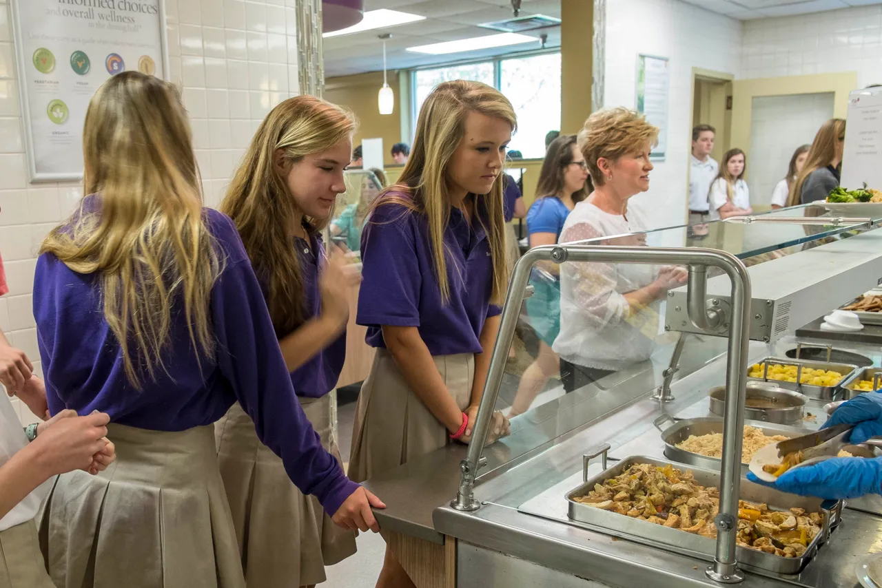 Members of the Darlington Community check out the selection in the hot food line.