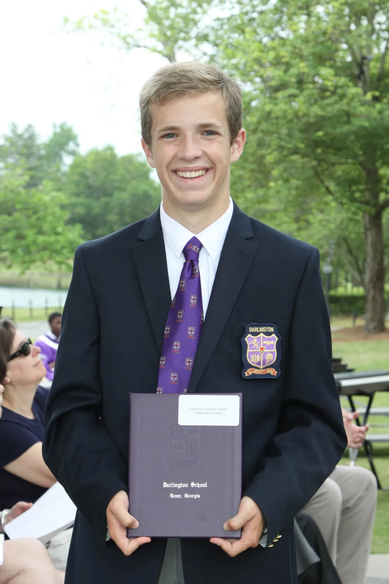 Spencer Fields ('15) proudly displays his diploma at Commencement on Saturday, less than one day after winning his second state title.