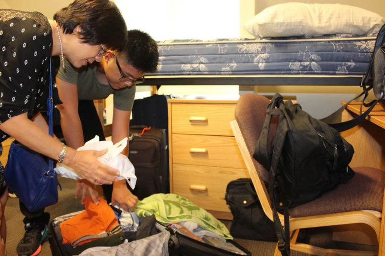 Ha Ho helps her son sophomore Long Nguyen unpack in his dorm room at Summerbell House at Darlington School. (Photo credit: Kristina Wilder / RN-T.com)