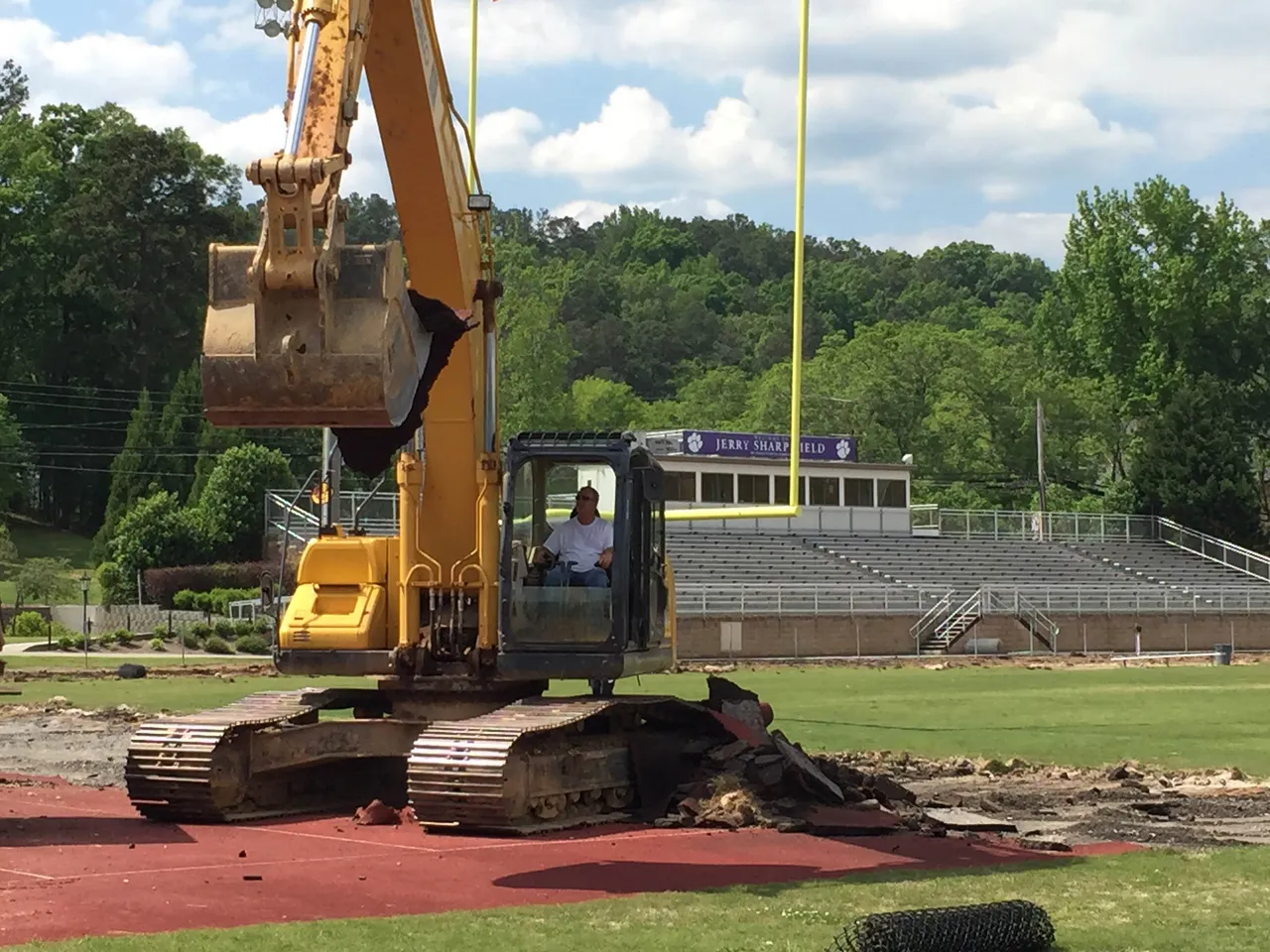 Construction crews begin work moving dirt and taking up the old rubber track on Jerry Sharp Field in late May.