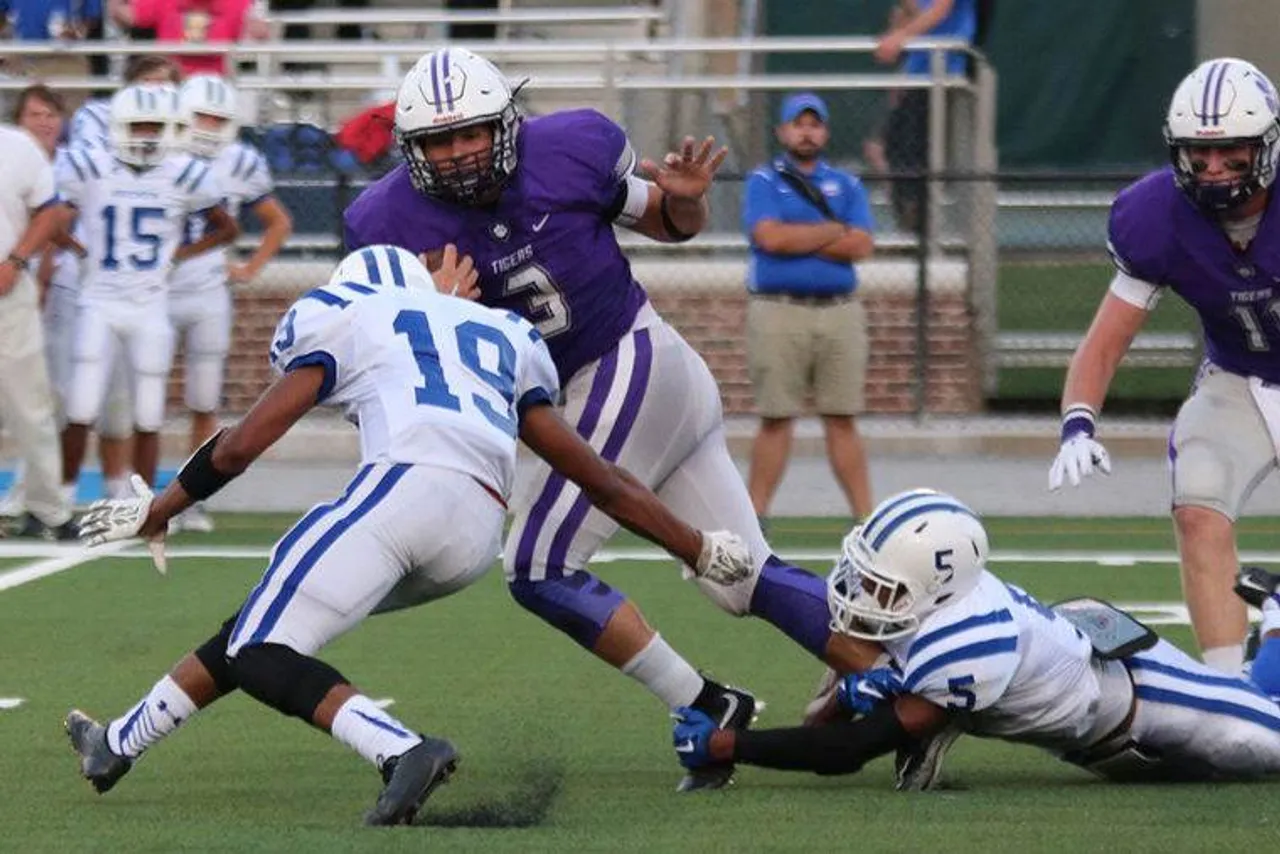 Senior Landon Lawrence (3) tries to escape from Bremen's Kyle Bailey (5) while looking to get past Jordan Mellilo during a game Friday, Aug. 28, 2015. (Photo credit: Jeremy Stewart/RN-T.com)