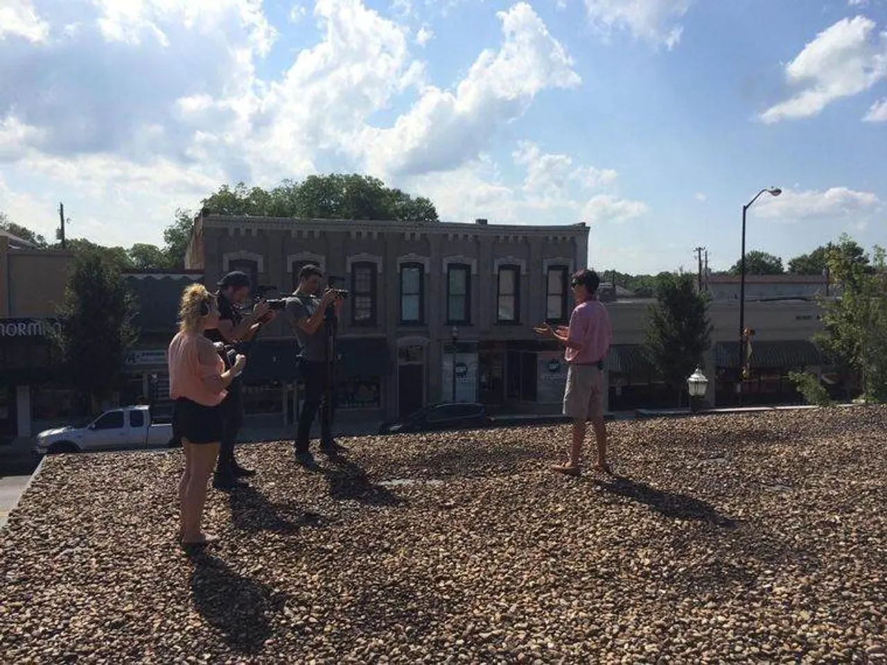 Senior Daniel Morris (in striped shirt) shows a film crew around the former Coca-Cola bottling plant on Main Street where he plans to open the Cedartown Coca-Cola Museum in June 2016. (Photo credit: The Polk County Standard Journal)