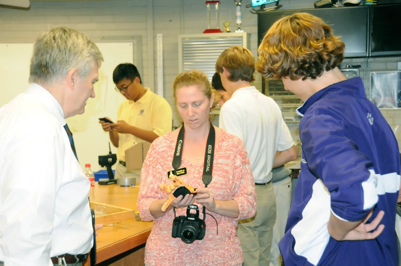 Geek Week Rome founder Charles Howell (left), Angela Devine of the Greater Rome Chamber of Commerce, and junior Ash Herndon examine a prosthetic hand that was created in Darlington's Makerspace.