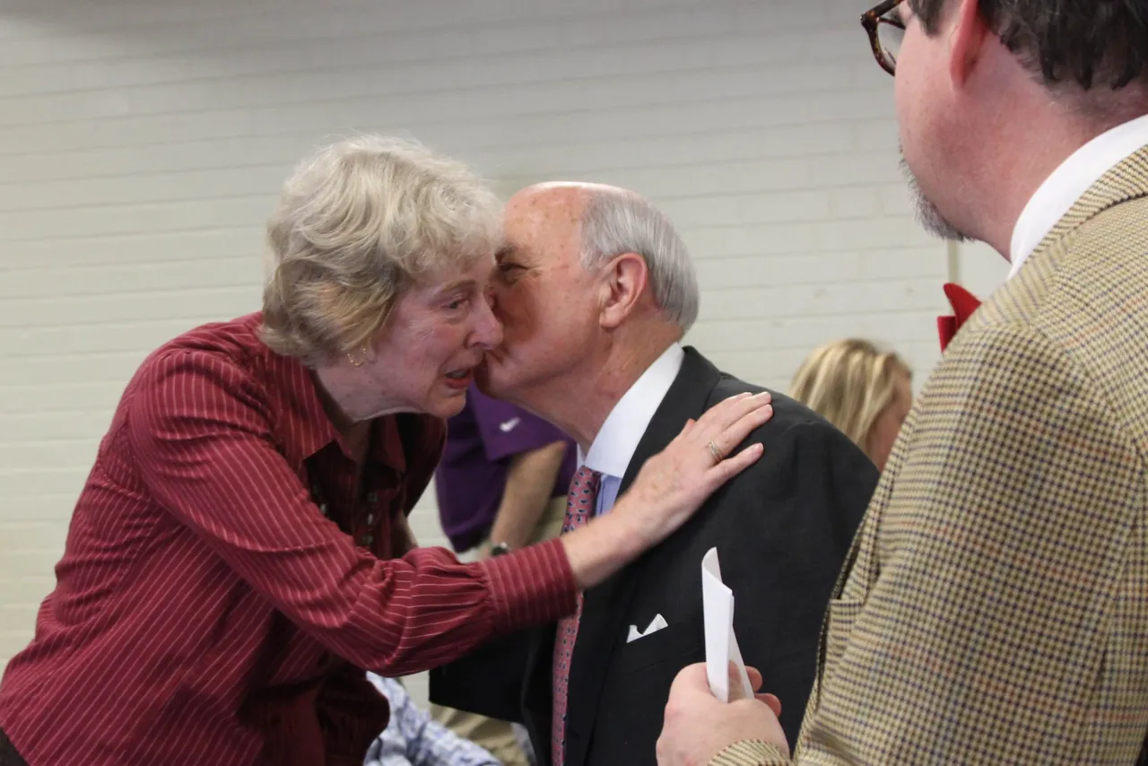Dean of College Guidance Sam Moss ('63) (center) greets Betsy Awsumb, widow of George Awsumb, as history teacher Brian Inman looks on.