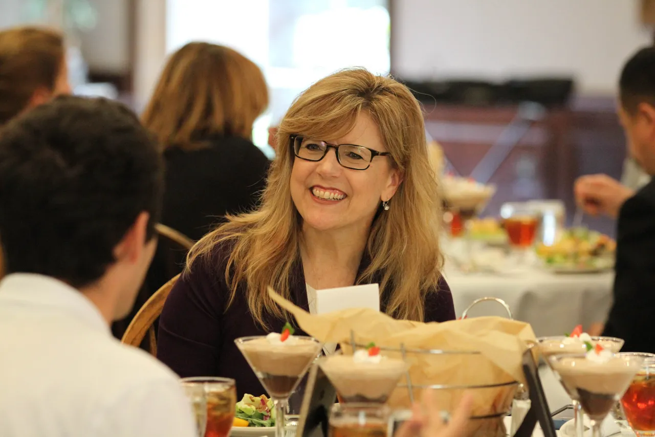 Alice Carson, senior international trade manager with the Georgia Department of Economic Development, interacts with students over lunch in the Dodd Banquet Room.