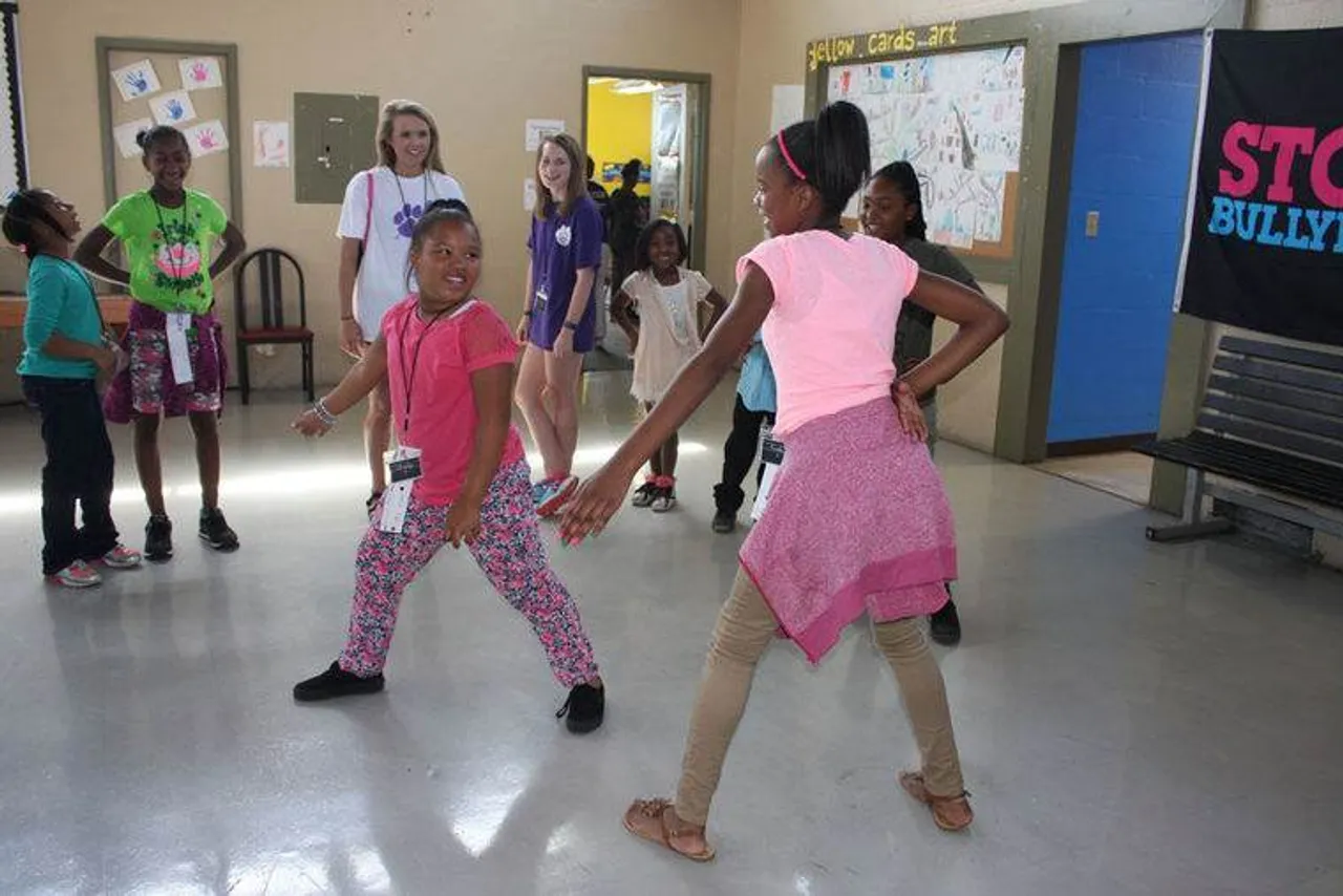 Brooklyn Gibson (left) and Eriahna Heath play Ninja, an acting warm-up game, at the Boys & Girls Club during Darlington's senior service day. (Kristina Wilder / RN-T.com)