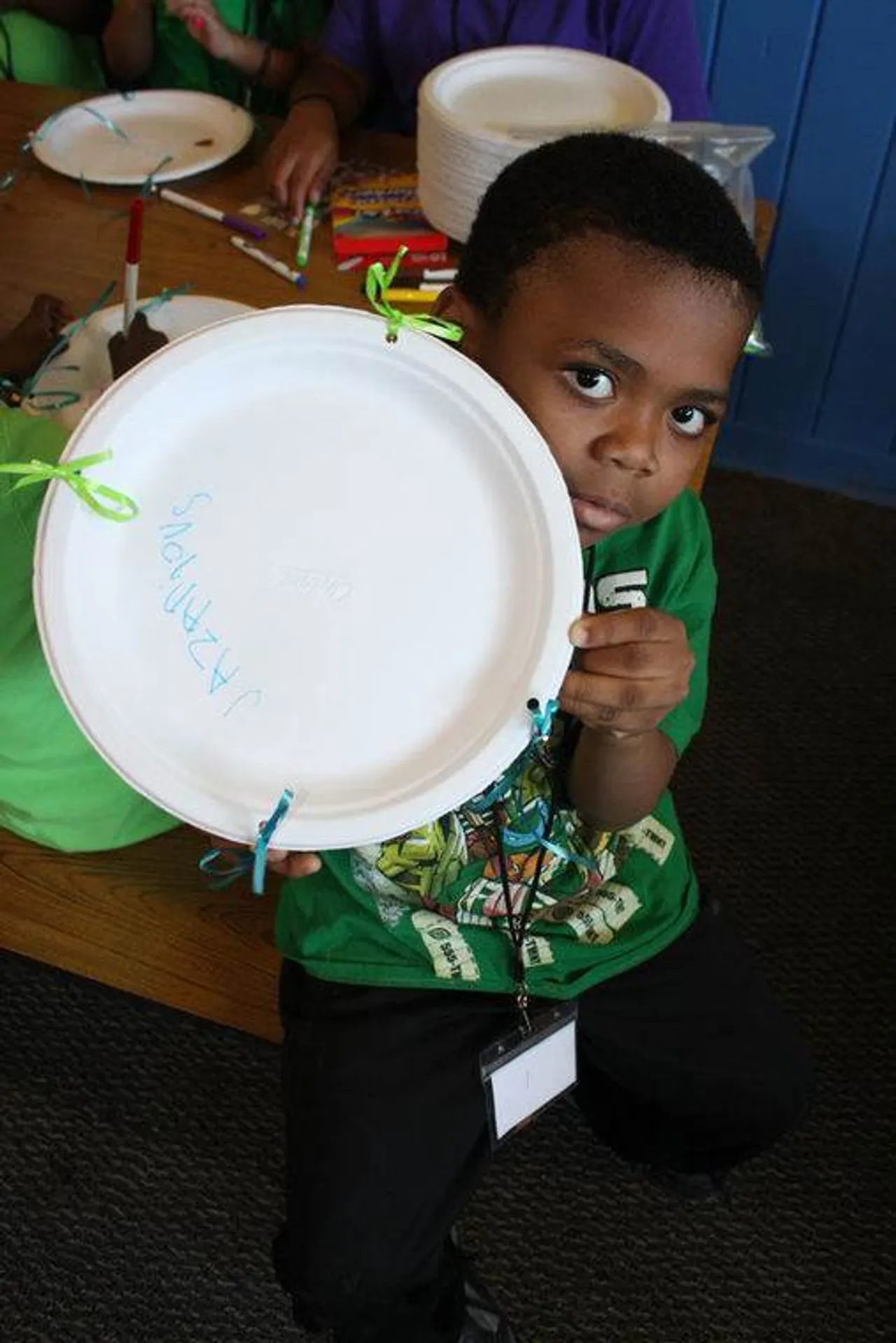 Jazarious Chubbs shows off his tambourine-making skills. (Kristina Wilder / RN-T.com)