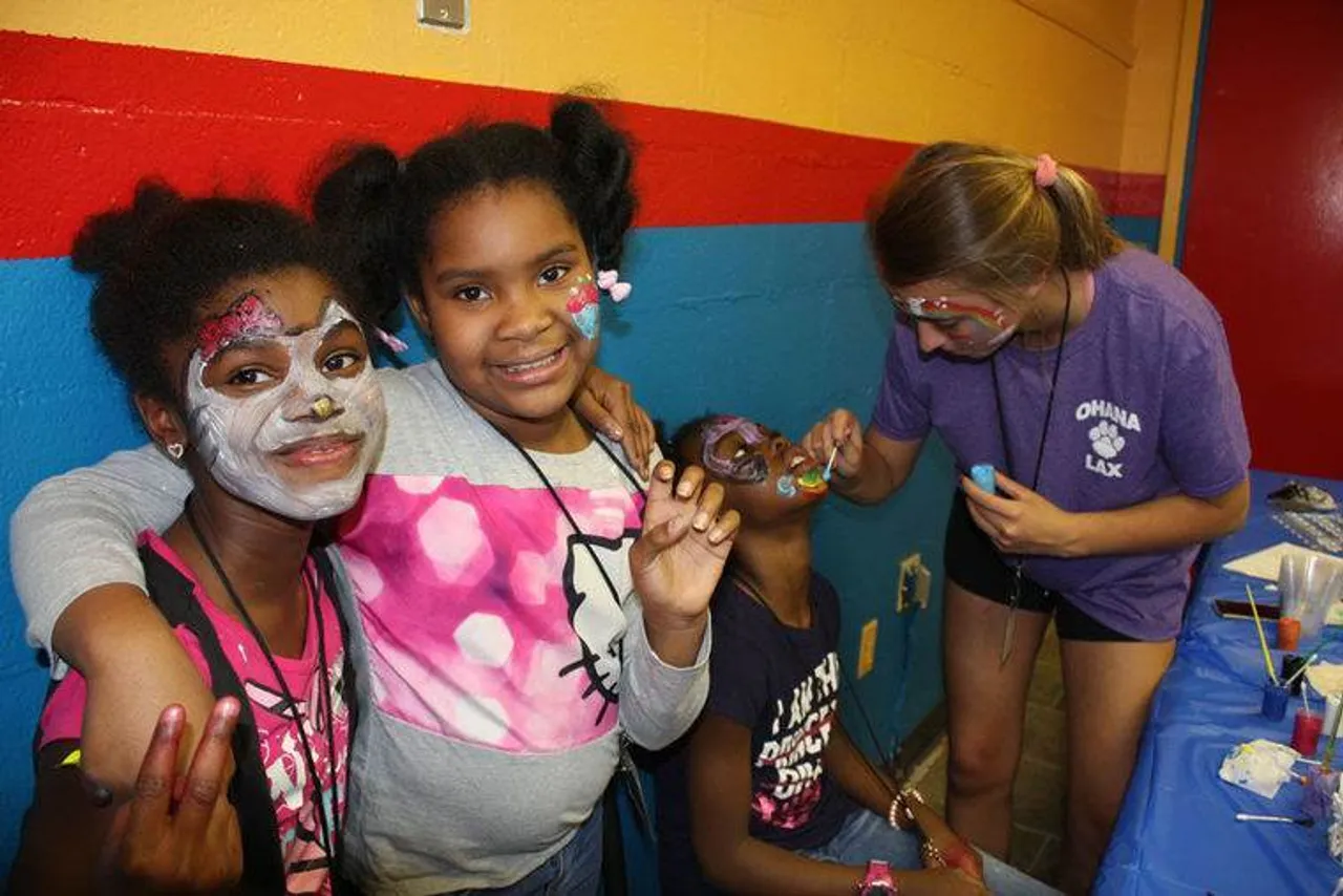 Makayla Blount (from left) and Aria Dublin wait as their friend Tamara Wright gets her face painted by Darlington senior Lillie Bertelkamp. (Kristina Wilder / RN-T.com)