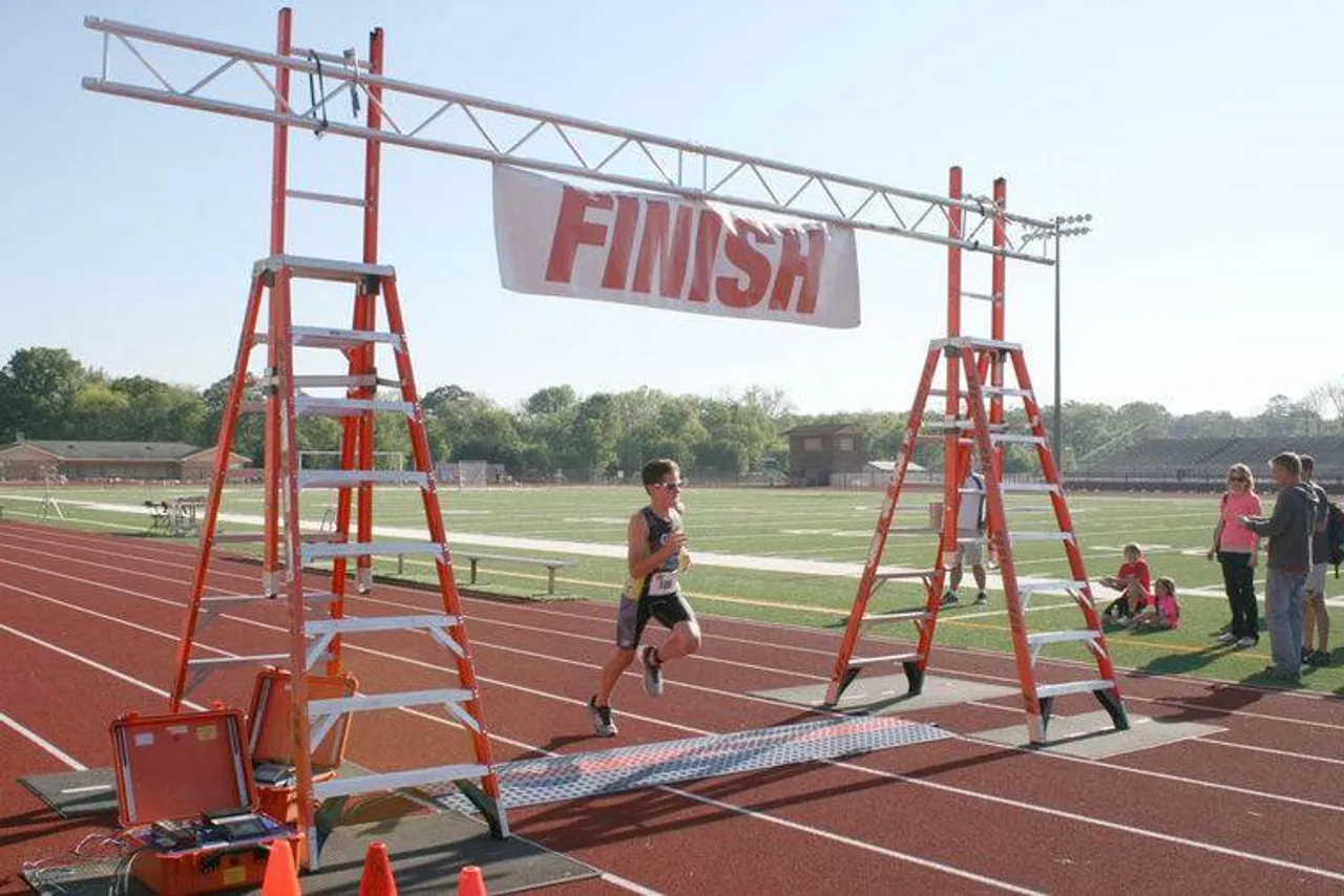 Easton Gray crosses the finish line at the Tri for the Kids triathlon at Darlington School on Sunday, April 24, 2016. (Sarah Lane/RN-T)
