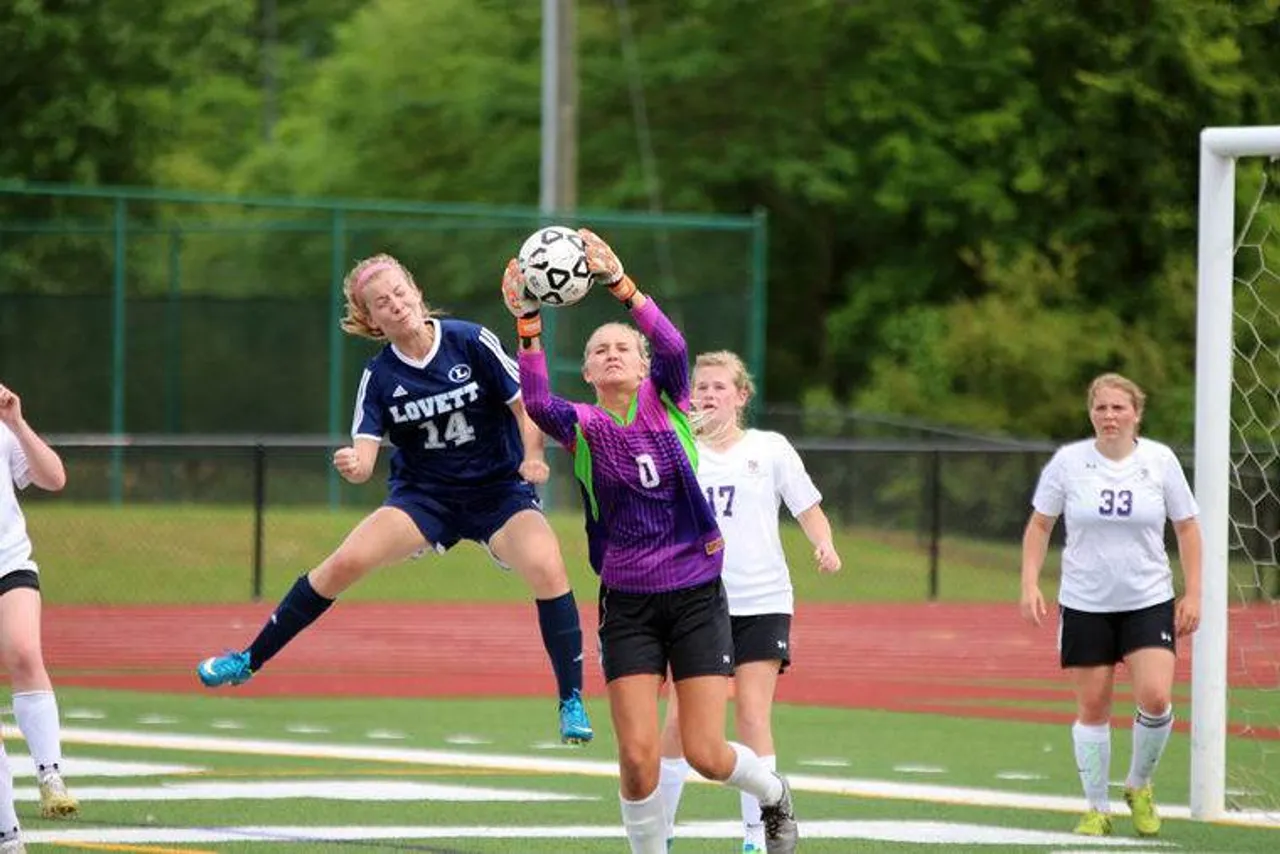 Darlington keeper senior Keara Evans (right) makes a save in front of the goal before colliding with Lovett's Megan Kring during a match in the first round of the Class AA state playoffs Friday, April 29, 2016, at Darlington's Chris Hunter Stadium. (Jeremy Stewart/RN-T.com)