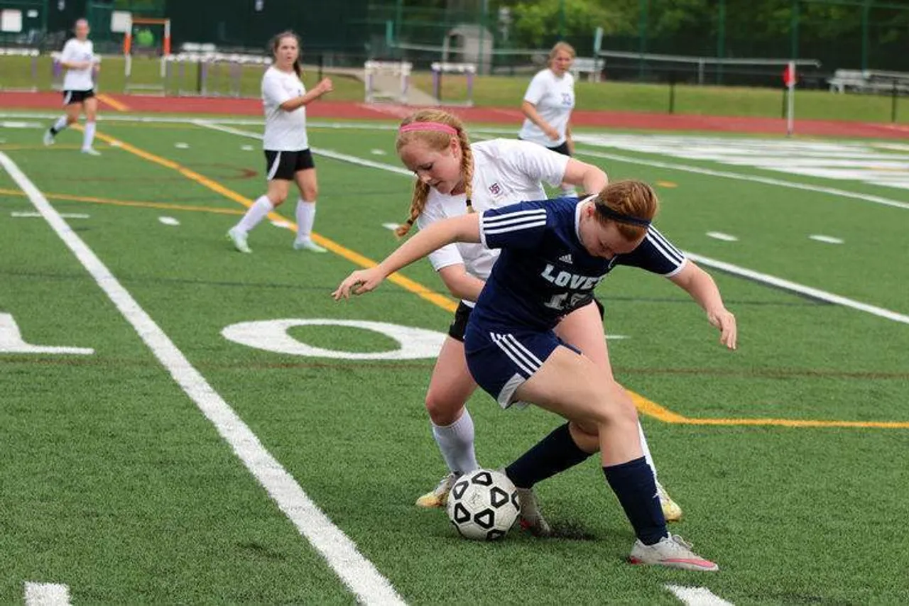 Junior Anna Katherine Cates (left) works against Lovett's Christina Karem to try and get to the ball during a match in the first round of the Class AA state playoffs Friday, April 29, 2016, at Darlington's Chris Hunter Stadium. (Jeremy Stewart/RN-T.com)