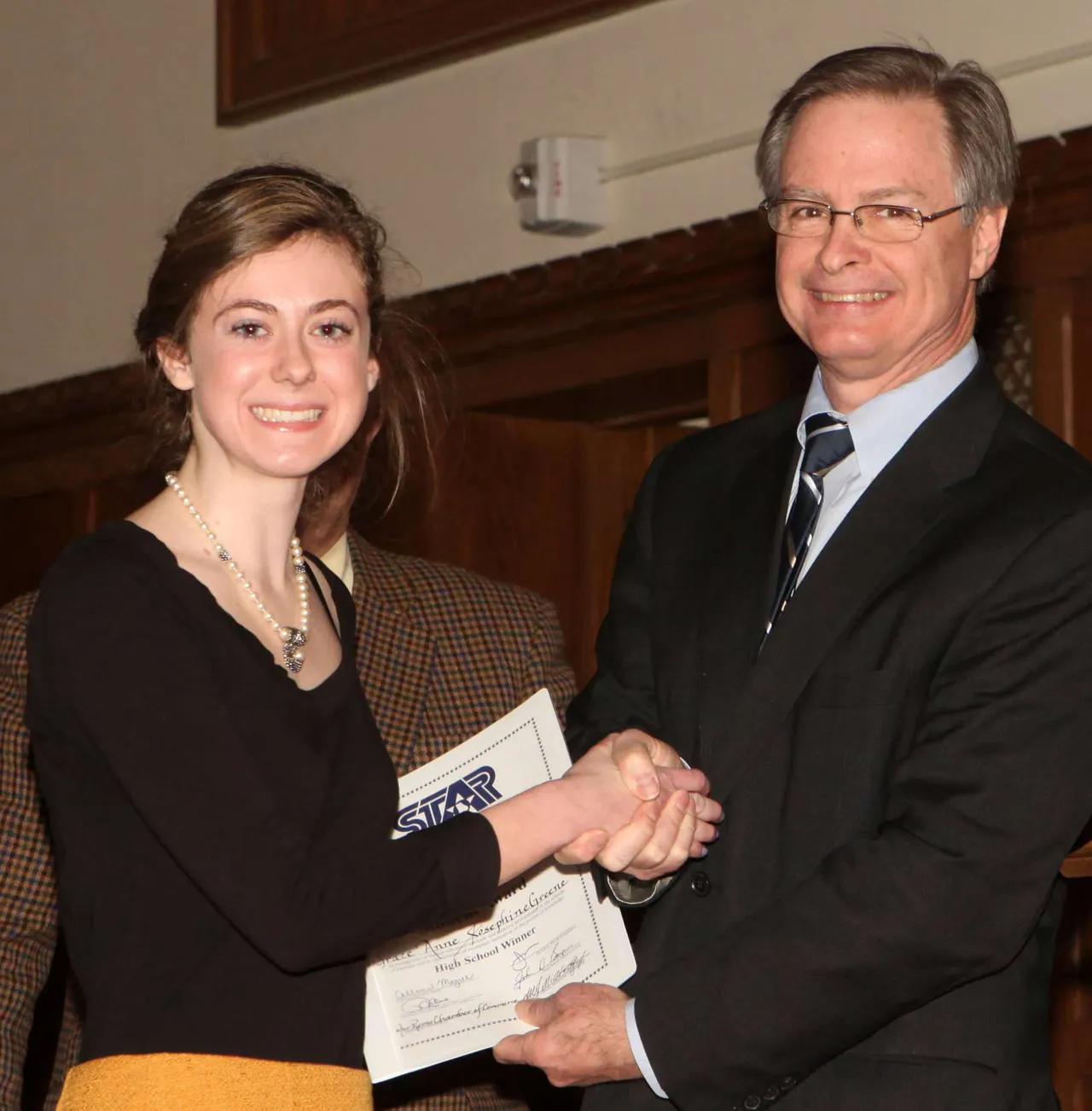 Al Hodge presents Grace Greene with the STAR Student certificate.
