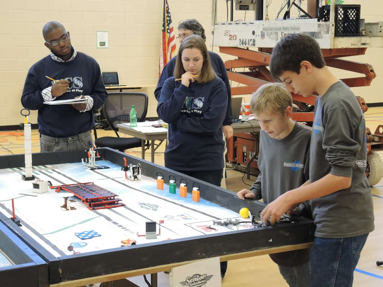 The Middle School DarBots finished first in a field of 16 teams at the Dalton Regional First Lego League tournament. The team surpassed the second highest robot game score by 45 points and received great accolades from judges for their work with senior citizens. Working with staff and residents at our local Winthrop Court Assisted Living Center, the DarBots designed and constructed an improved back rest for rollator walkers. The team shared their prototype with patients and plan to tie into the service part of Darlington’s mission by actually producing their invention for Winthrop Court residents. Robotics is a great example of blending science, technology and engineering through creative innovation. Here, Jack Eady (’19) and Ian Kinney (’17) compete in the tournament.