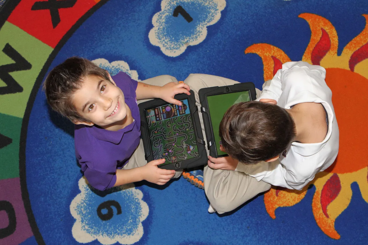 Every morning during center time, students grab iPads and work through various subject areas and apps including interactive books, writing practice, math exercises, coloring pages and word games. The activities not only develop their core knowledge and skills development, but help them start developing 21st Century learning skills such as responsible use and digital creation that will be reinforced through all grades.
Here, Kostas Pateritsas (’25) and Garrett Kizziah (’25) work on their morning activities.