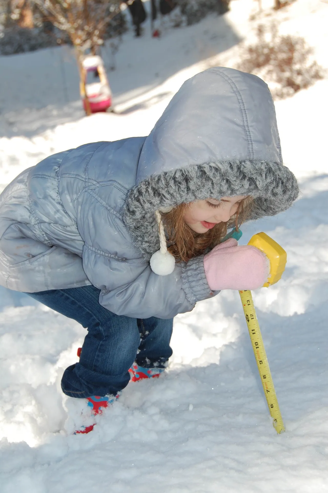 Early Learning Academy student Madeline Earnest (K5) measures the snow as part of her distance learning assignment.