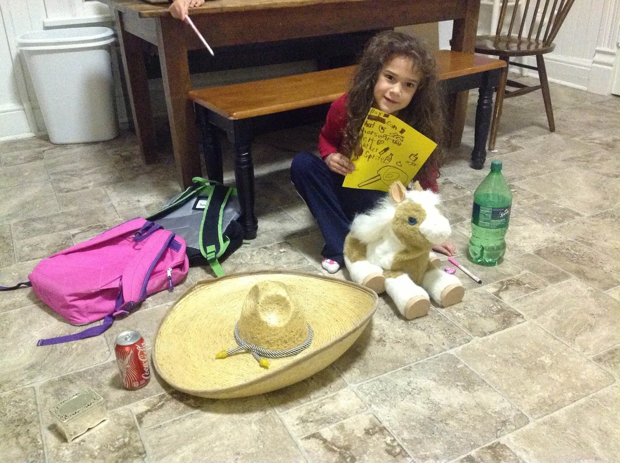First-grader Chatlie Hernandez puts seven items from around her house in alphabetical order as part of her distance learning assignment.