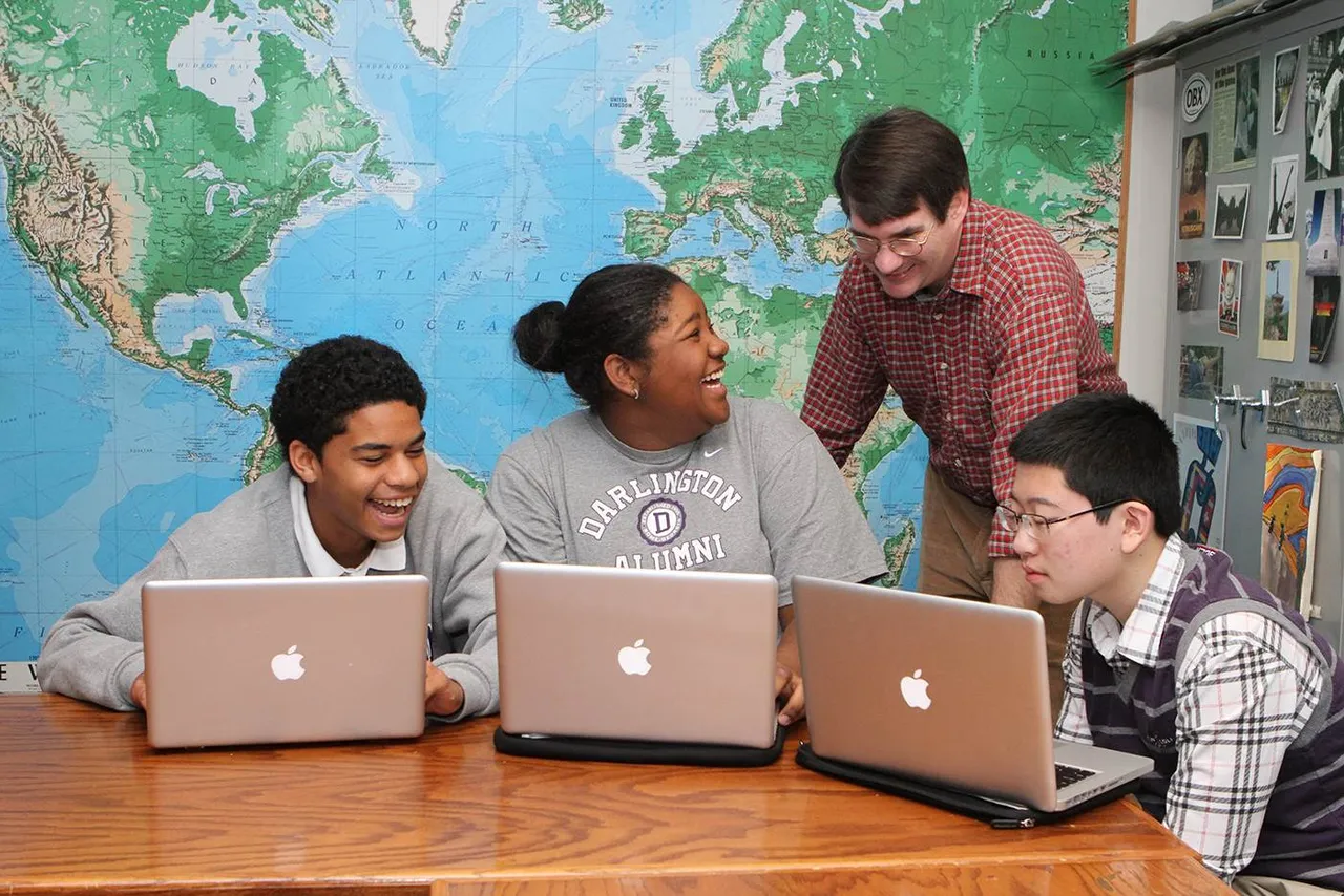 Upper School teacher Brian Inman works with students in his World Religions class.