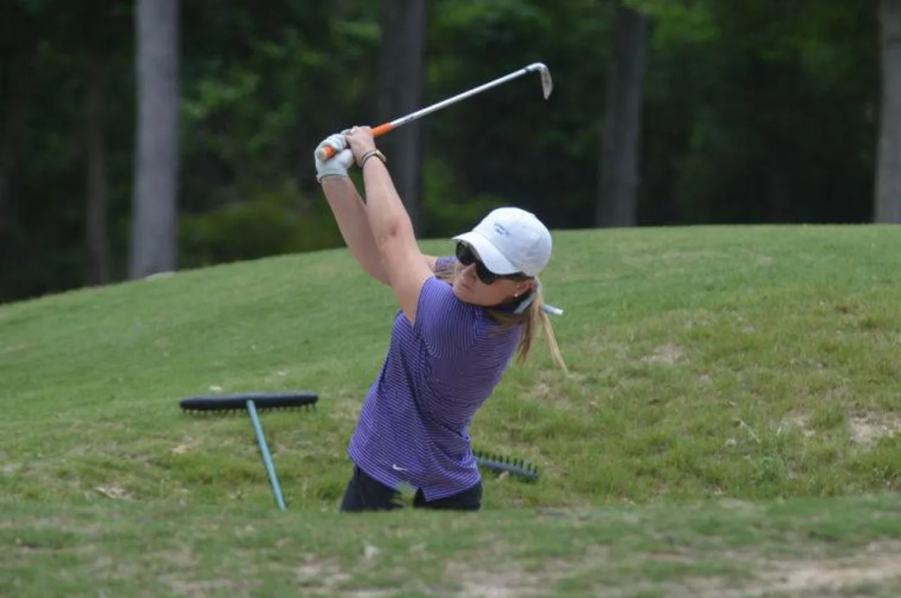 Hannah Mae Deems ('14) hits a shot out of a sand trap during the state golf championship. (Photo by Jim Alred / Rome News-Tribune)