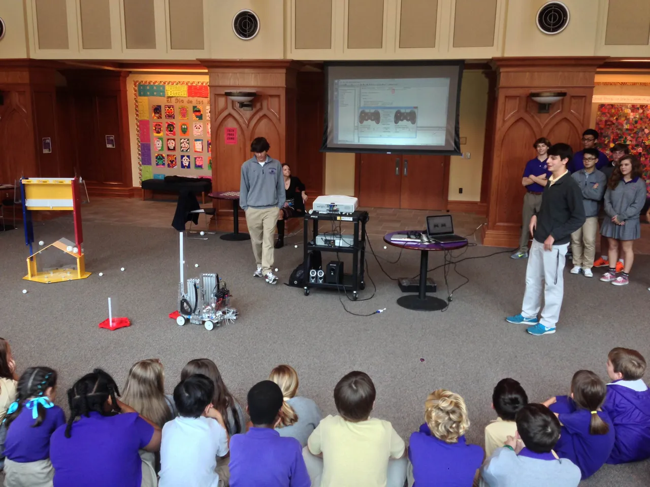 The Upper School DarBots team presents to 3rd-8th grade students in the Ledbetter Commons.