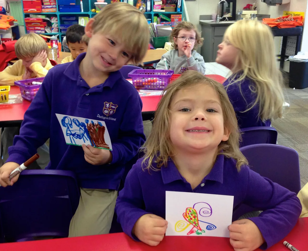 Pre-Kindergarten students Whit Watters and Callie Eady drew pictures to go with pajama bundles for foster children in the community.