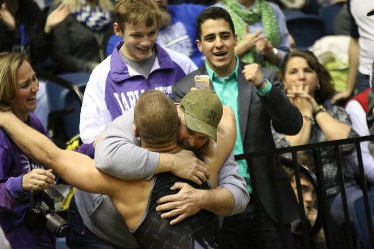 Senior Hayden Cook hugs his family after winning the Class AA
State Title at 182 on Saturday in Macon. (Jim Alred/RN-T)