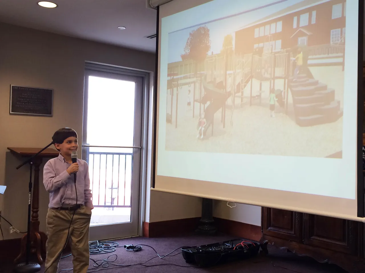 Third-grader Tommy Cowan provides an overview of a possible playground setup using a digital rendering.