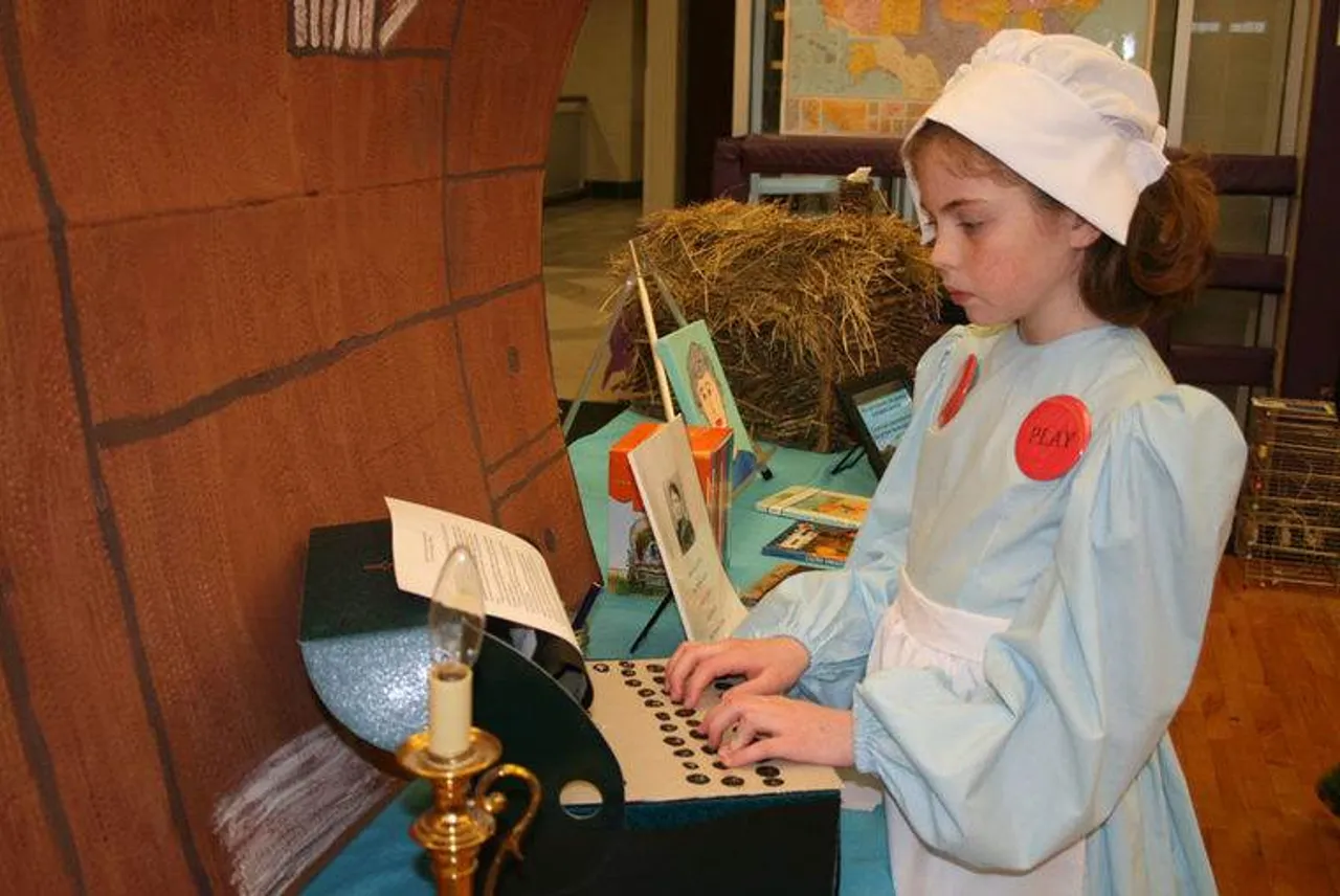 Abigail Baggett, as Laura Ingalls Wilder, poses at her typewriter during the Wax Museum at Darlington School. (Photo credit: Kristina Wilder / RN-T.com)